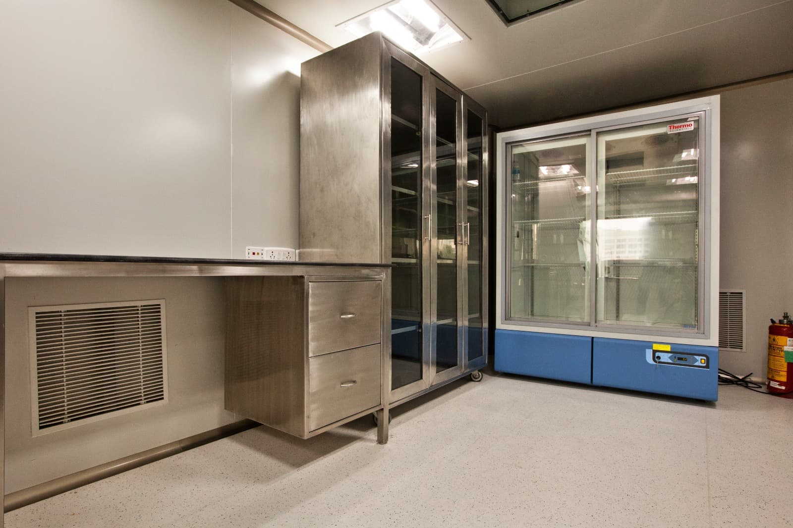 Stainless steel cleanroom furniture with glass-door cabinet and Thermo Scientific cold storage