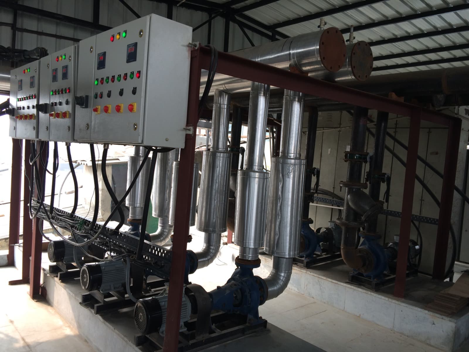 Chilled-water pump skid with vertical inline pumps, insulated headers and control panels
