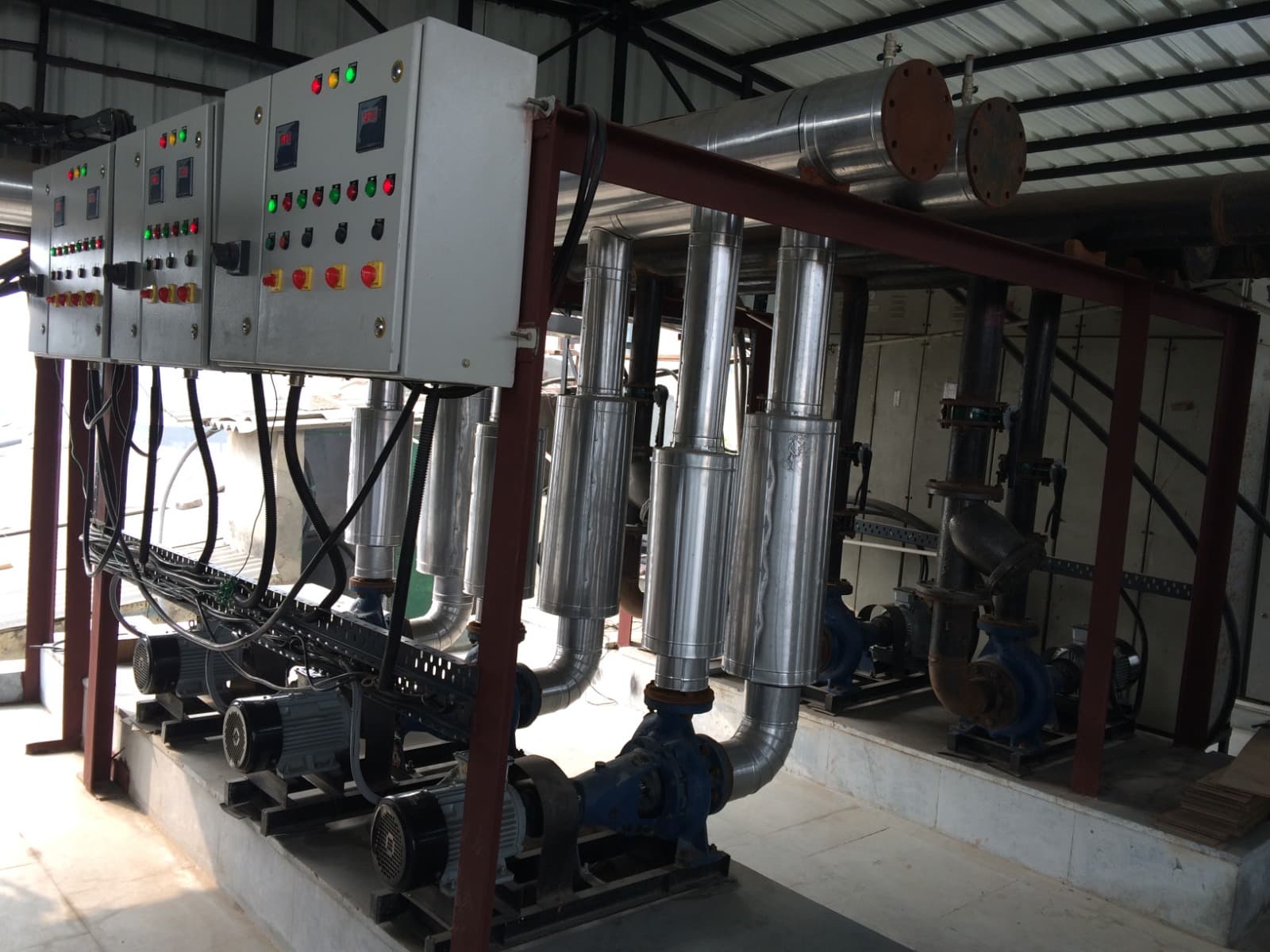Pump room with mounted control panels, insulated pipework and end-suction pumps