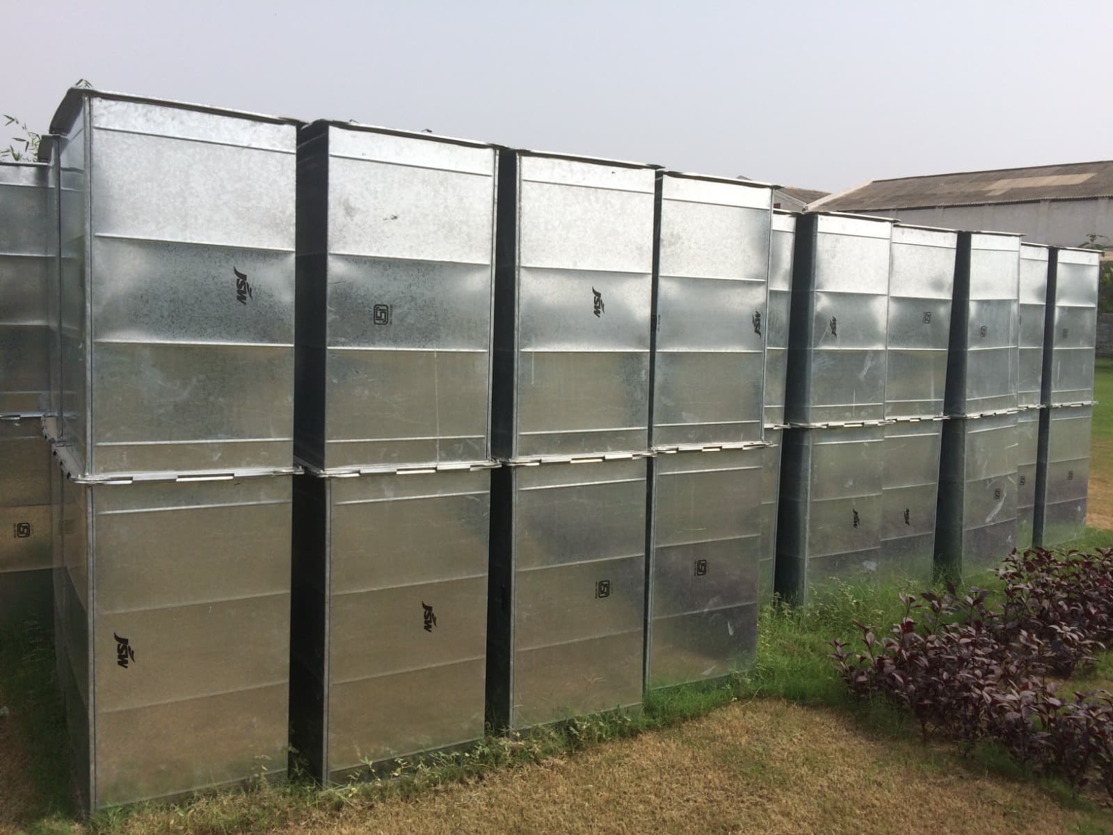 Stacked galvanised sheet (JSW) rectangular duct sections in the storage yard