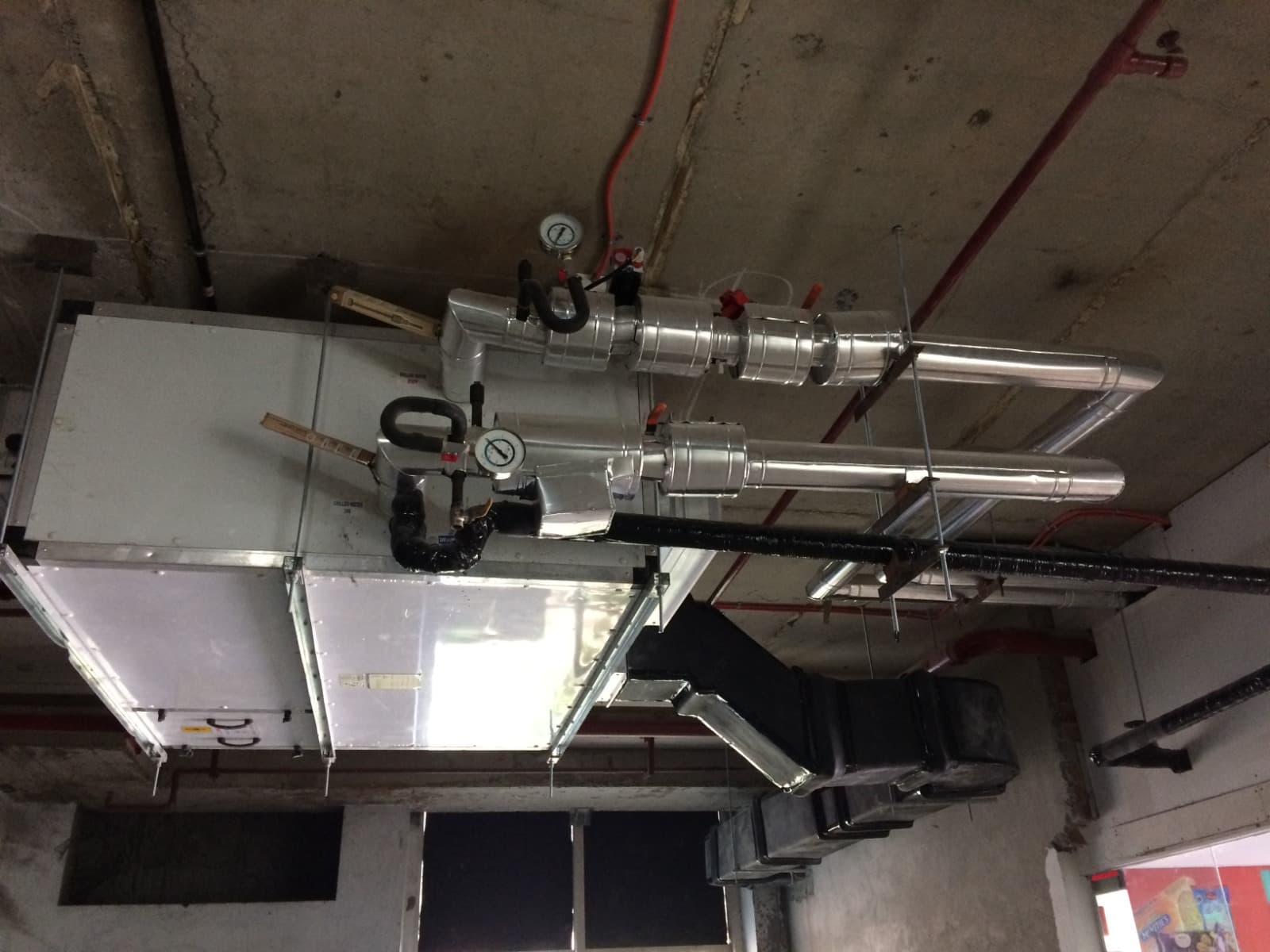 Ceiling-suspended chilled-water AHU with insulated flow-and-return connections