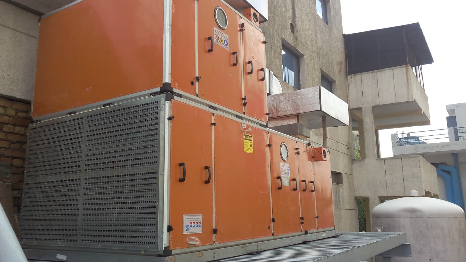 Stacked orange double-skin ZECO air handling units on an external platform