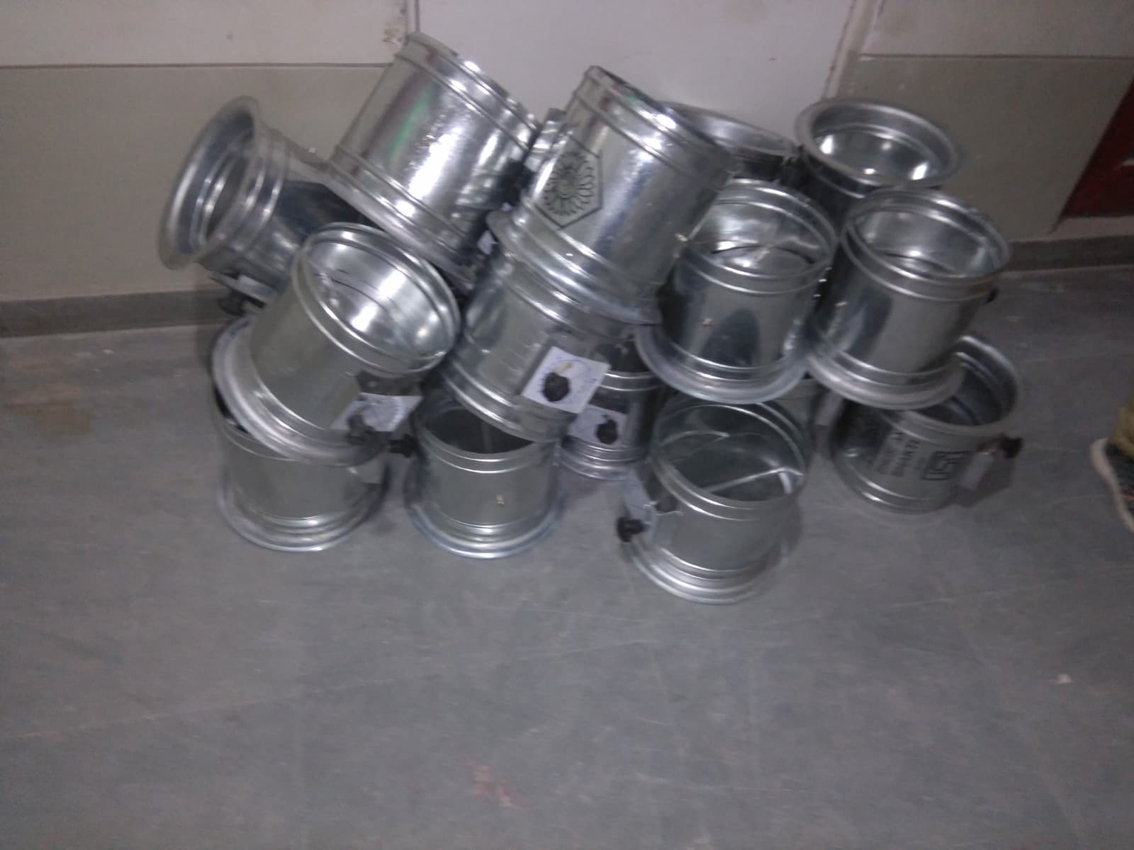 ISI-marked circular volume control dampers stacked on site