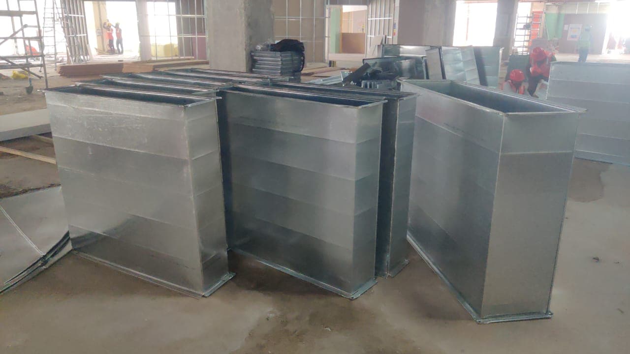 Site-fabricated GI rectangular duct sections staged during high-side installation