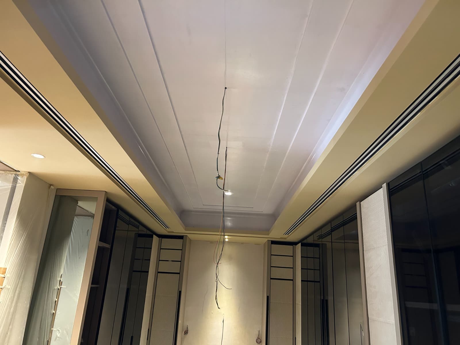 Premium interior with a cove-lit false ceiling and concealed linear slot diffusers