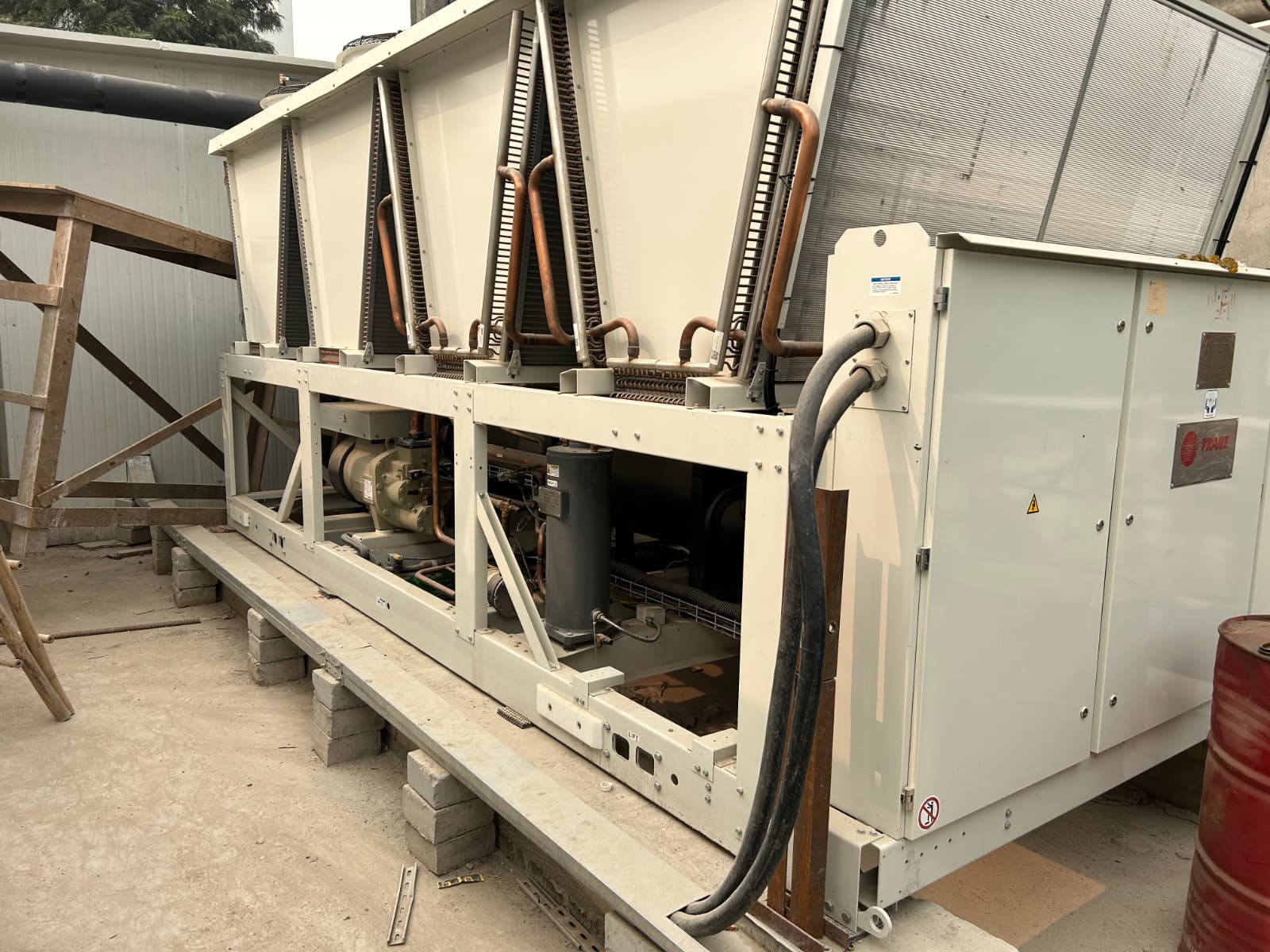 Air-cooled Trane screw chiller with condenser coils installed on a terrace
