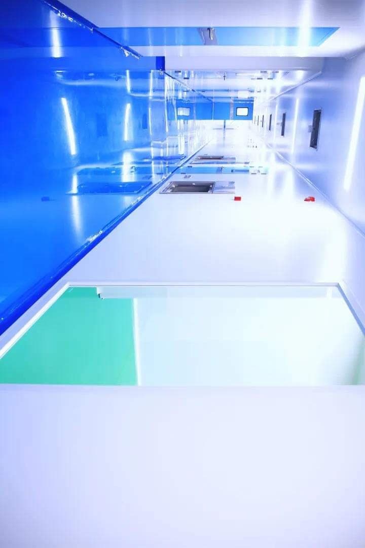 Cleanroom corridor with glossy epoxy floor and terminal HEPA supply grilles
