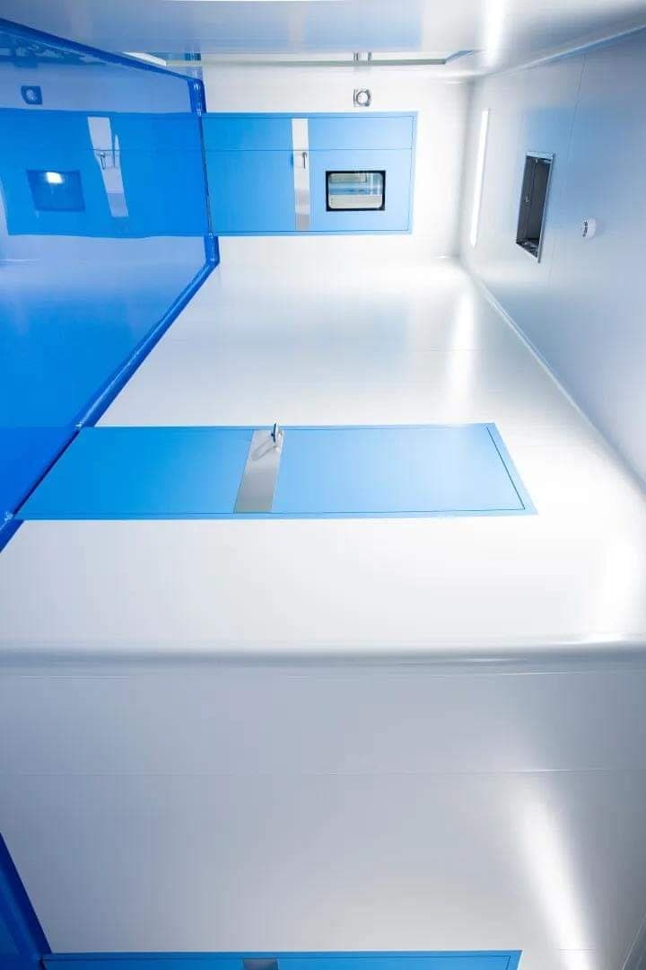 Cleanroom with blue dado, white epoxy floor and a stainless pass-box window