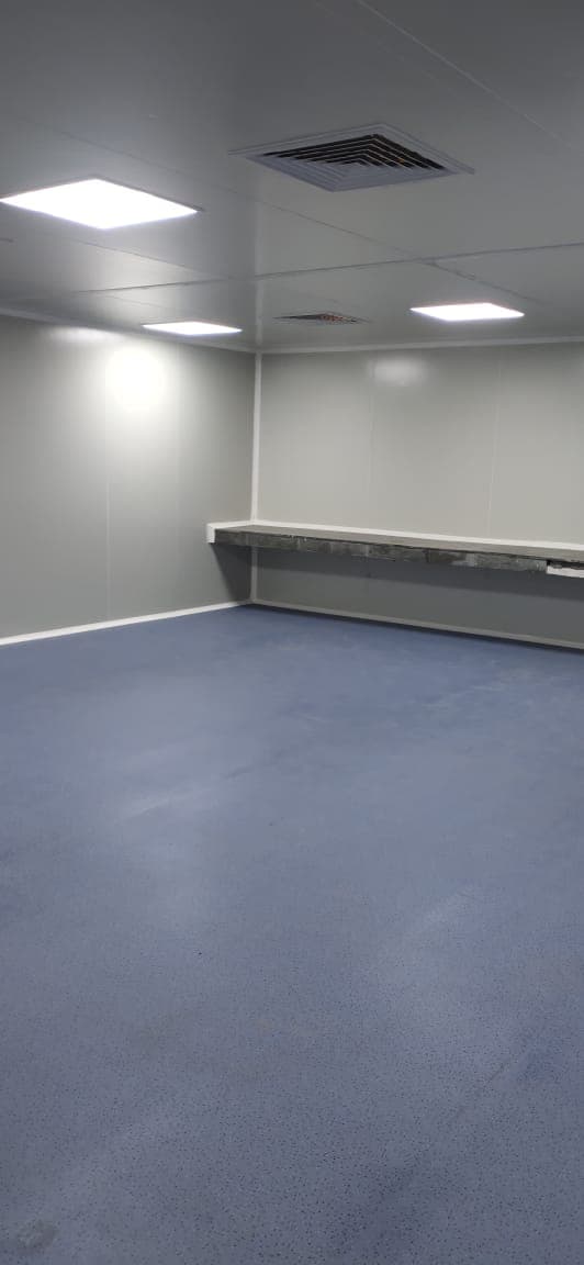 Cleanroom with blue vinyl floor, ceiling supply diffuser and return-air grille